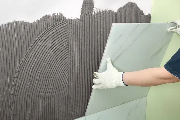 Depositphotos 274450540 stock photo worker installing ceramic tile on